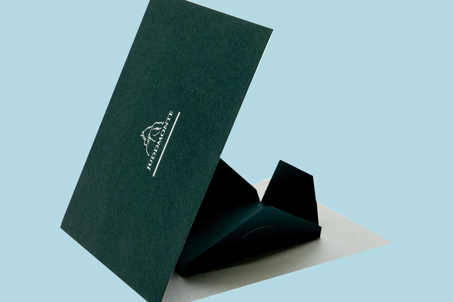 Bespoke presentation folder by City Images: dark green soft-touch board with white foil-blocked crest and die-cut insert.