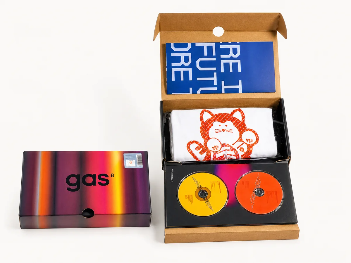Kraft mailer box open to show a printed blue insert, branded tea towel and two picture-disc records