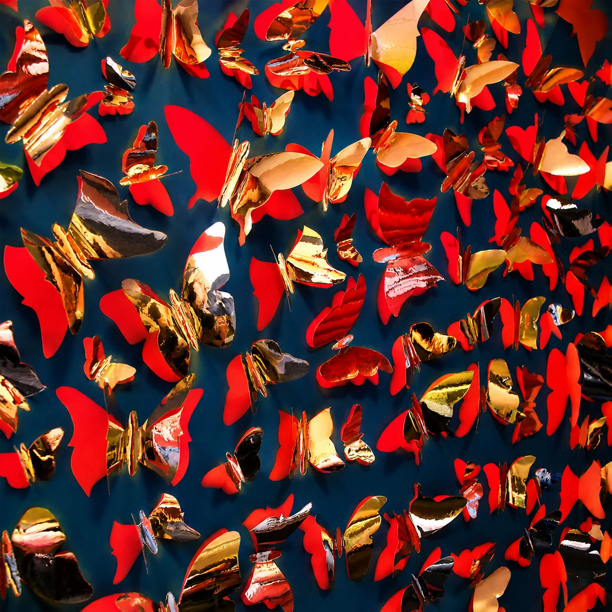 Lalique butterfly wall installation, hundreds of CNC die-cut red card and gold mirror foil butterflies hand-pinned by City Images London