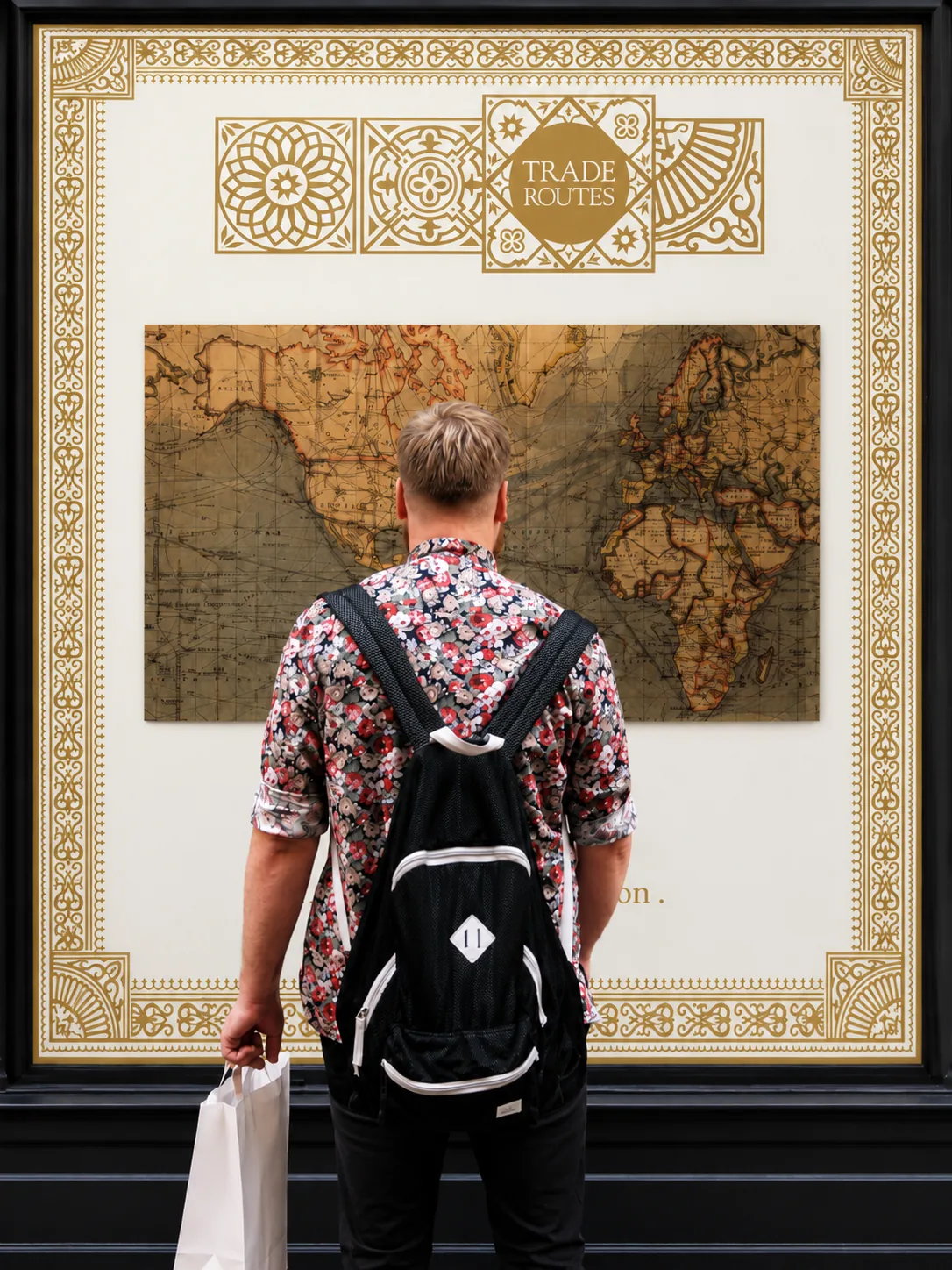 Person beside a large framed Trade Routes poster showing full A0 scale, printed by City Images London