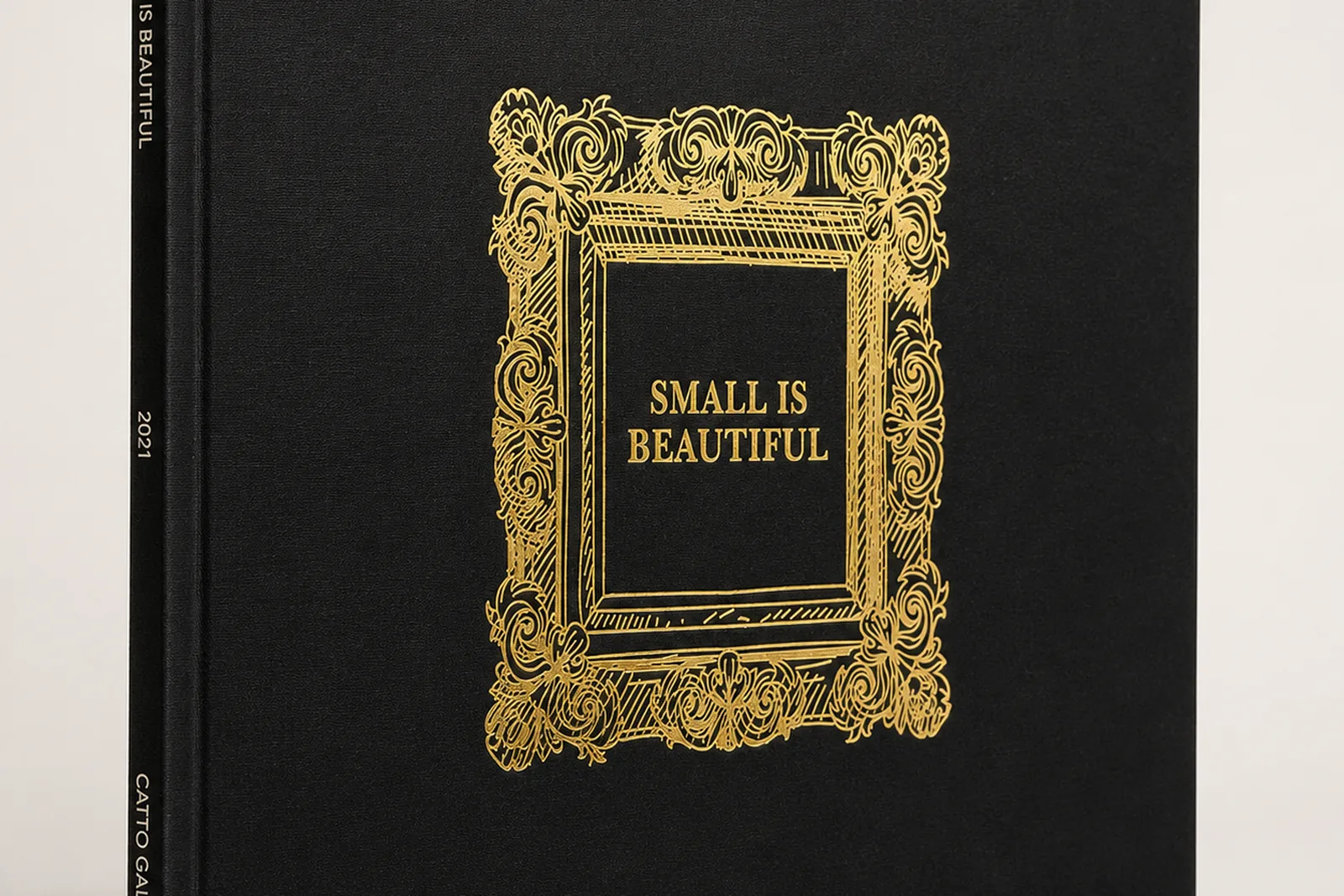 Foil-finished luxury packaging samples on oak workbench