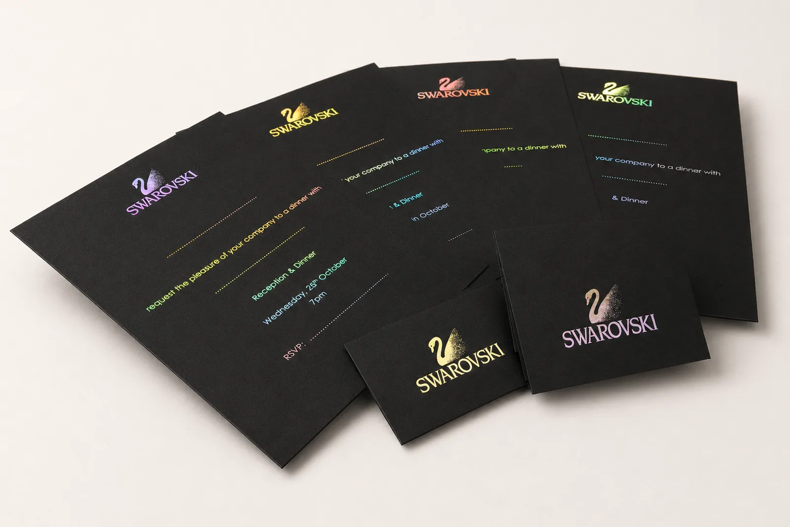 Holographic foil invitation set on black stock with swan motif, multi-card showcase