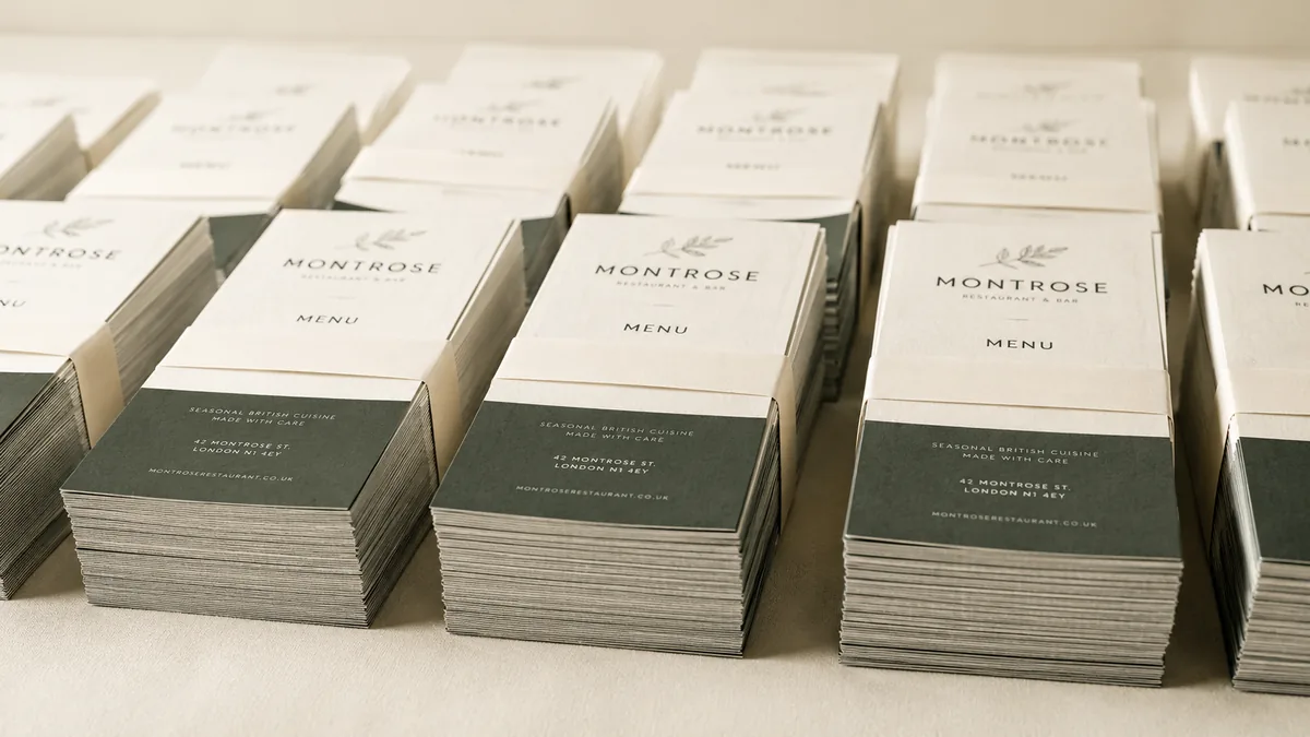 Banded stacks of DL restaurant menu flyers lined up for an evening drop